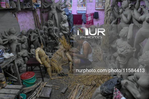 An artist makes an idol of goddess Durga out of clay ahead of the Durga Puja festival at a workshop in Kolkata, India, on September 18, 2024...