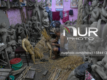 An artist makes an idol of goddess Durga out of clay ahead of the Durga Puja festival at a workshop in Kolkata, India, on September 18, 2024...