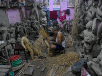 An artist makes an idol of goddess Durga out of clay ahead of the Durga Puja festival at a workshop in Kolkata, India, on September 18, 2024...