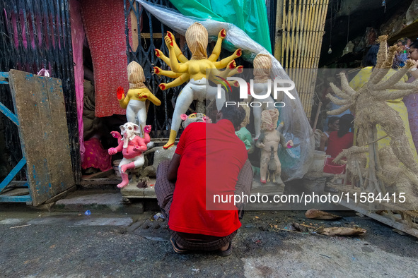 An artist makes an idol of goddess Durga at a potter's hub in Kolkata, India, on September 18, 2024, ahead of the Durga Puja festival. 