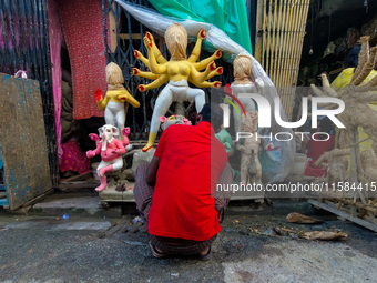 An artist makes an idol of goddess Durga at a potter's hub in Kolkata, India, on September 18, 2024, ahead of the Durga Puja festival. (