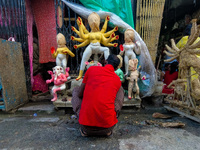 An artist makes an idol of goddess Durga at a potter's hub in Kolkata, India, on September 18, 2024, ahead of the Durga Puja festival. (