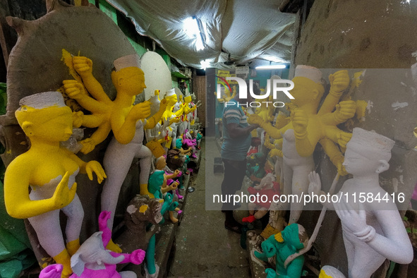 An artist makes an idol of goddess Durga at a potter's hub in Kolkata, India, on September 18, 2024, ahead of the Durga Puja festival. 