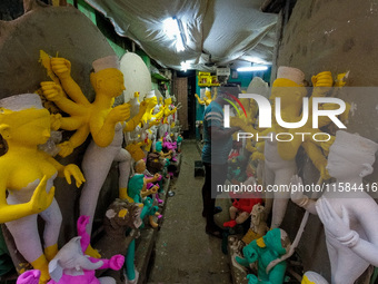 An artist makes an idol of goddess Durga at a potter's hub in Kolkata, India, on September 18, 2024, ahead of the Durga Puja festival. (