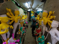 An artist makes an idol of goddess Durga at a potter's hub in Kolkata, India, on September 18, 2024, ahead of the Durga Puja festival. (