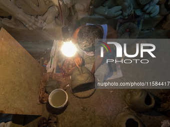 An artist makes the head of an idol ahead of the Durga Puja festival at a potters' hub in Kolkata, India, on September 18, 2024. (