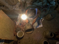 An artist makes the head of an idol ahead of the Durga Puja festival at a potters' hub in Kolkata, India, on September 18, 2024. (