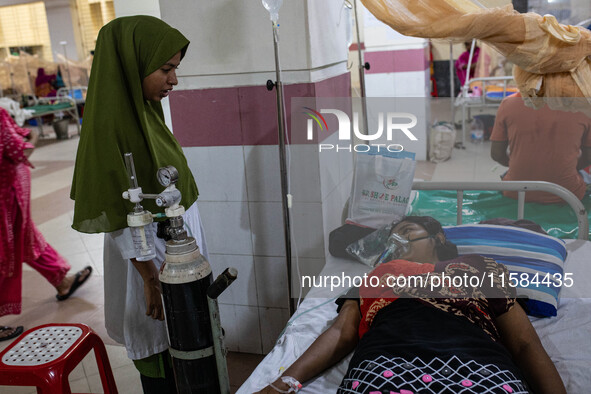 Jannatul Fedaus Maya (17), a dengue patient with breathing problems, receives oxygen support at Mugda Medical College and Hospital in Dhaka,...