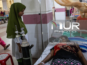 Jannatul Fedaus Maya (17), a dengue patient with breathing problems, receives oxygen support at Mugda Medical College and Hospital in Dhaka,...