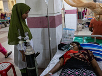 Jannatul Fedaus Maya (17), a dengue patient with breathing problems, receives oxygen support at Mugda Medical College and Hospital in Dhaka,...