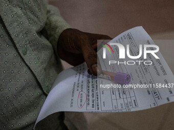 An attendant of a dengue patient submits a blood sample to the lab while Jannatul Fedaus Maya (17), a dengue patient with breathing problems...