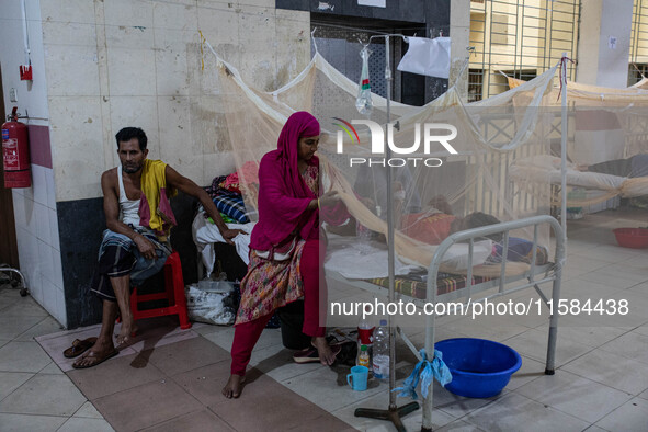 Dengue patients lie inside mosquito nets at Mugda Medical College and Hospital in Dhaka, Bangladesh, on September 18, 2024. 