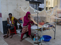 Dengue patients lie inside mosquito nets at Mugda Medical College and Hospital in Dhaka, Bangladesh, on September 18, 2024. (