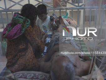 Dengue patients lie inside mosquito nets at Mugda Medical College and Hospital in Dhaka, Bangladesh, on September 18, 2024. (