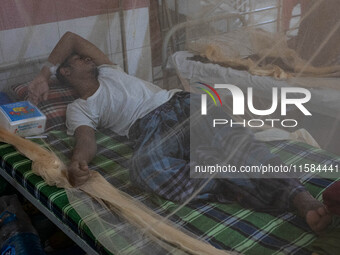 Dengue patients lie inside mosquito nets at Mugda Medical College and Hospital in Dhaka, Bangladesh, on September 18, 2024. (