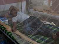 Dengue patients lie inside mosquito nets at Mugda Medical College and Hospital in Dhaka, Bangladesh, on September 18, 2024. (