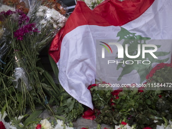 A portrait of Lebanon Hezbollah's Secretary-General Hassan Nasrallah and a Lebanese flag are pictured next to flowers placed in front of the...