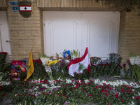 A portrait of Lebanon Hezbollah's Secretary-General Hassan Nasrallah and a Lebanese flag are pictured next to flowers placed in front of the...