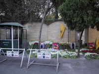 Portraits of a young Lebanese girl who was killed in a deadly pager attack, a flag of Lebanon's Hezbollah, and flowers are placed in front o...