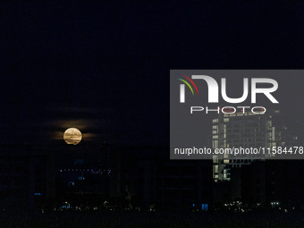 The Harvest Moon rises behind the casino, hotel, and resort, City Of Dreams, in Limassol, Cyprus, on September 18, 2024. The term ''harvest...