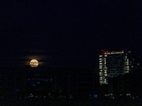 The Harvest Moon rises behind the casino, hotel, and resort, City Of Dreams, in Limassol, Cyprus, on September 18, 2024. The term ''harvest...