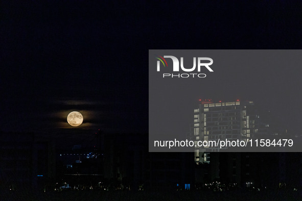 The Harvest Moon rises behind the casino, hotel, and resort, City Of Dreams, in Limassol, Cyprus, on September 18, 2024. The term ''harvest...