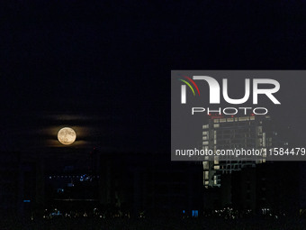 The Harvest Moon rises behind the casino, hotel, and resort, City Of Dreams, in Limassol, Cyprus, on September 18, 2024. The term ''harvest...