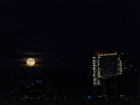 The Harvest Moon rises behind the casino, hotel, and resort, City Of Dreams, in Limassol, Cyprus, on September 18, 2024. The term ''harvest...