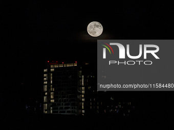 The Harvest Moon rises behind the casino, hotel, and resort, City Of Dreams, in Limassol, Cyprus, on September 18, 2024. The term ''harvest...