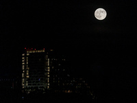 The Harvest Moon rises behind the casino, hotel, and resort, City Of Dreams, in Limassol, Cyprus, on September 18, 2024. The term ''harvest...