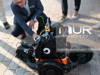 The Butty robot from the Danish robotics company demonstrates cleaning cigarette butts on the opening day of Deutsche Telekom's Digital X ev...