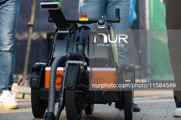 The butty robot from a Danish robotics company demonstrates cleaning cigarette butts on the opening day of Deutsche Telekom's digital X even...