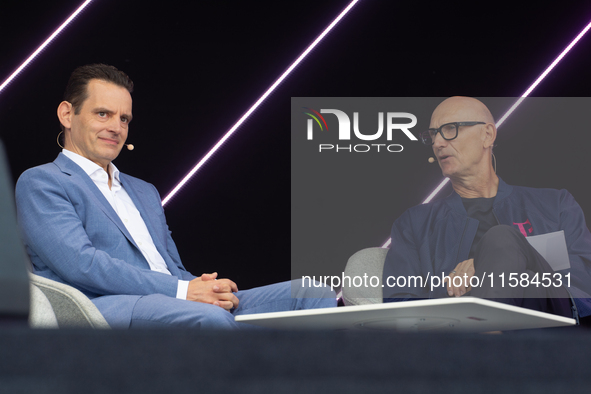 Timotheus Hoettges, CEO of Deutsche Telekom, talks to Leonhard Birnbaum, Chief Executive Officer of E.ON SE, on the stage at Media Park on t...