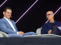 Timotheus Hoettges, CEO of Deutsche Telekom, talks to Leonhard Birnbaum, Chief Executive Officer of E.ON SE, on the stage at Media Park on t...