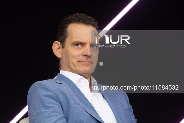 Leonhard Birnbaum, Chief Executive Officer of E.ON SE, stands on the stage at Media Park on the opening day of Deutsche Telekom's Digital X...