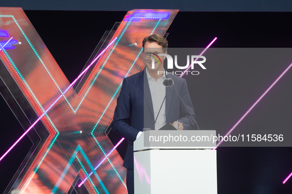 Hendrik Wust, Prime Minister of North Rhine-Westphalia, speaks on the stage at Media Park on the opening day of Deutsche Telekom's Digital X...