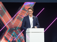 Hendrik Wust, Prime Minister of North Rhine-Westphalia, speaks on the stage at Media Park on the opening day of Deutsche Telekom's Digital X...