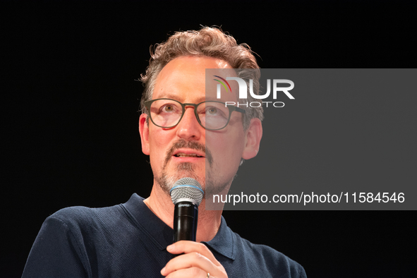 Dr. Eckart von Hirschhausen speaks on the opening day of Deutsche Telekom's digital X event at Media Park in Cologne, Germany, on September...