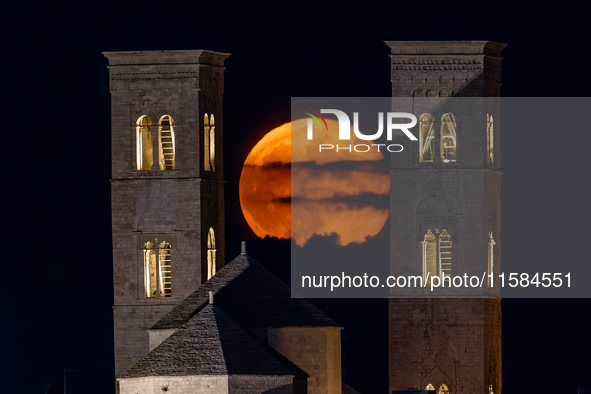 The September Supermoon, also called the Full Harvest Moon, rises between the towers of Molfetta Cathedral in Molfetta, Italy, on September...