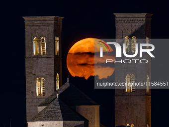 The September Supermoon, also called the Full Harvest Moon, rises between the towers of Molfetta Cathedral in Molfetta, Italy, on September...