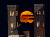 The September Supermoon, also called the Full Harvest Moon, rises between the towers of Molfetta Cathedral in Molfetta, Italy, on September...