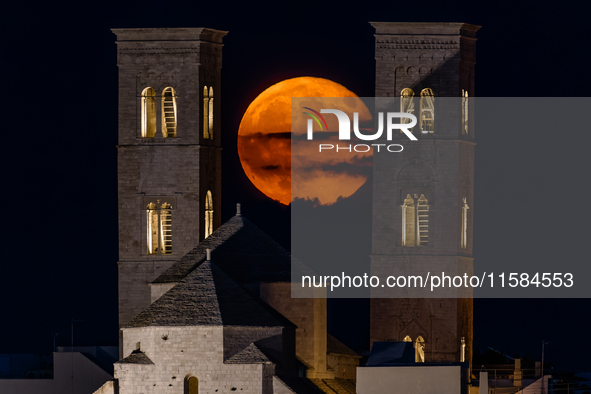 The September Supermoon, also called the Full Harvest Moon, rises between the towers of Molfetta Cathedral in Molfetta, Italy, on September...