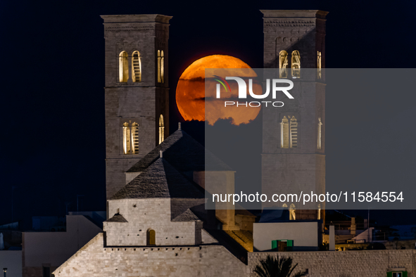 The September Supermoon, also called the Full Harvest Moon, rises between the towers of Molfetta Cathedral in Molfetta, Italy, on September...