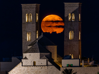 The September Supermoon, also called the Full Harvest Moon, rises between the towers of Molfetta Cathedral in Molfetta, Italy, on September...