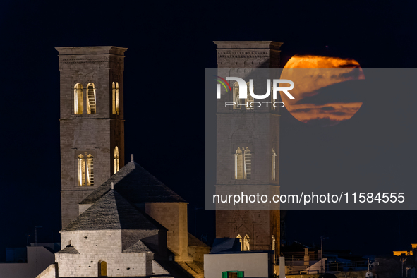 The September Supermoon, also called the Full Harvest Moon, rises between the towers of Molfetta Cathedral in Molfetta, Italy, on September...