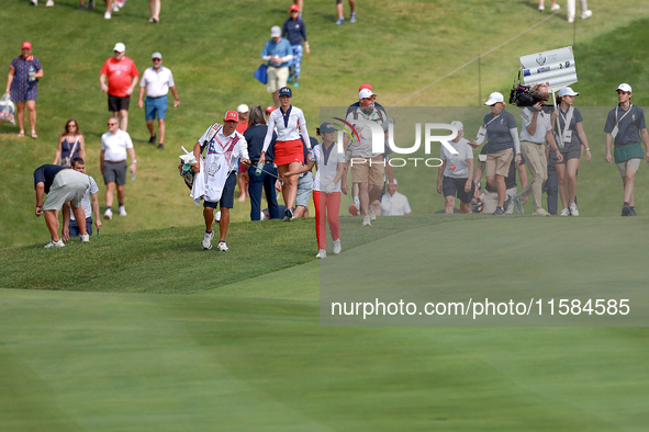 GAINESVILLE, VIRGINIA - SEPTEMBER 15: Andrea Lee of the United States walks with her caddie on the 12th fairway during the final round of th...