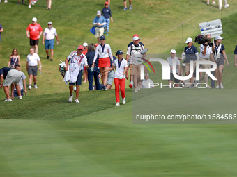 GAINESVILLE, VIRGINIA - SEPTEMBER 15: Andrea Lee of the United States walks with her caddie on the 12th fairway during the final round of th...