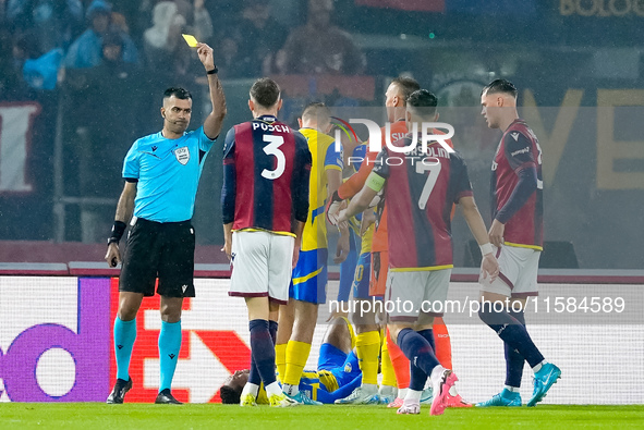 Stefan Posch of Bologna FC receives a yellow card during the UEFA Champions League 2024/25 League Phase MD1 match between Bologna FC and FC...