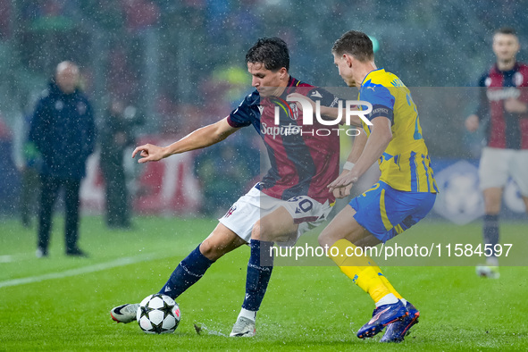 Giovanni Fabbian of Bologna FC and Mykola Matviyenko of FC Shakhtar Donetsk compete for the ball during the UEFA Champions League 2024/25 Le...