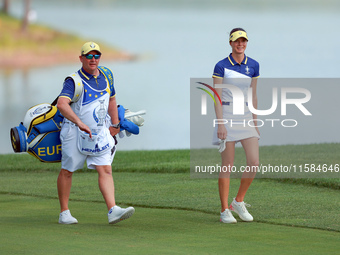 GAINESVILLE, VIRGINIA - SEPTEMBER 15: Esther Henseleit of Team Europe walks with her caddie on the 12th fairway during the final round of th...